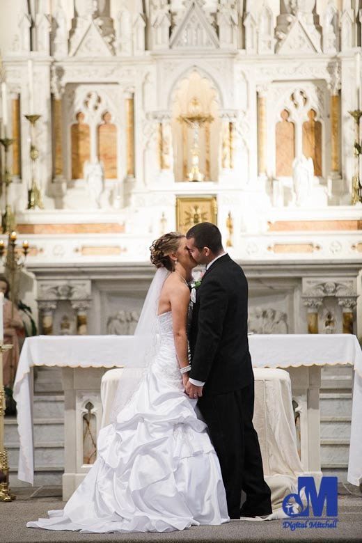 photographing the groom kissing the bride