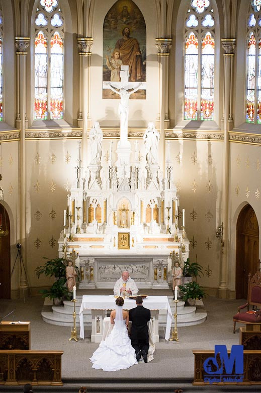 Photographing the bride and groom at the main alter