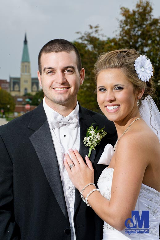 photographing the bride and groom with the church in the background