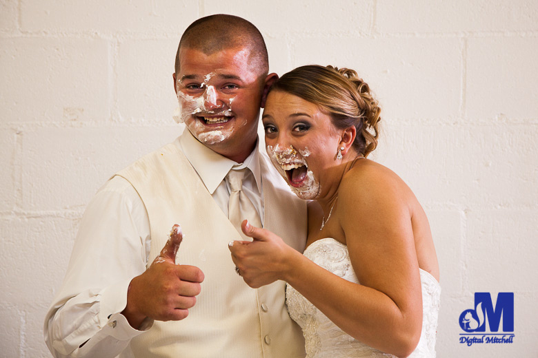 photograph of bride and groom with cake on face