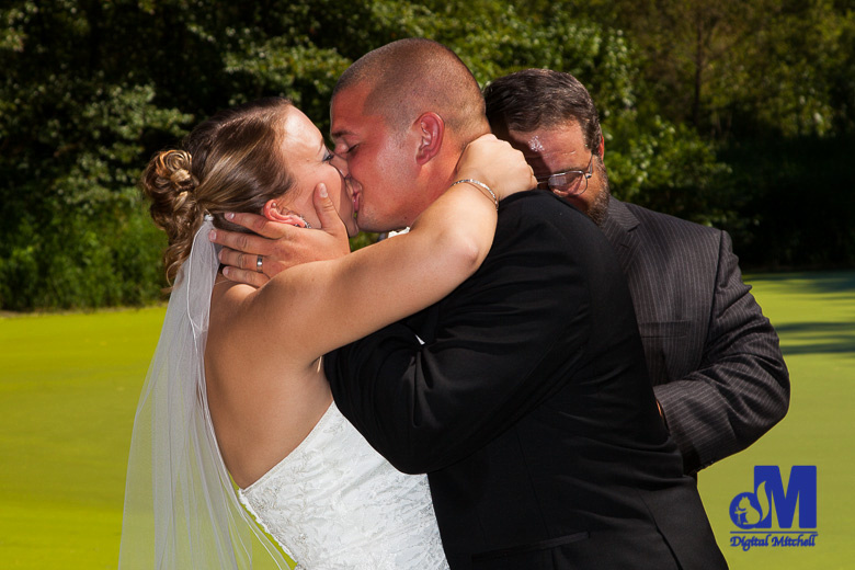 photograph of groom kissing bride