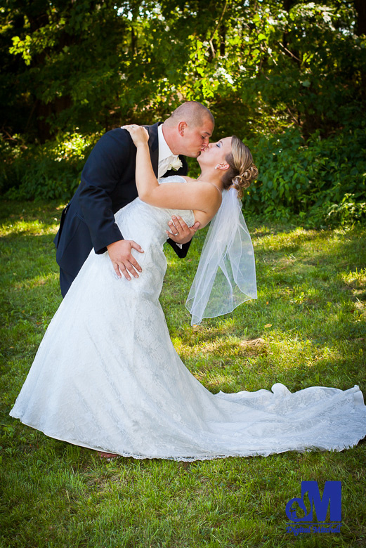 photograph of groom kissing bride