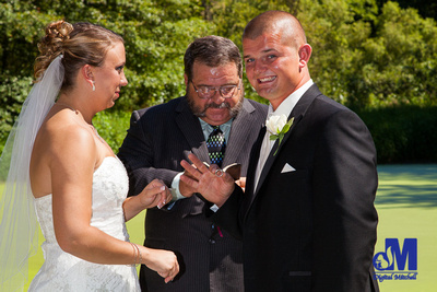 photograph of groom taking ring
